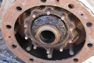 Dirty heavy truck drum brakes repair, disassembled hub bearing and brake drum with wheel pegs...