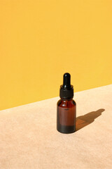 Cosmetic bottle with amber glass dropper. Natural beauty products. Mineral organic oil. Empty bottle for skin care.