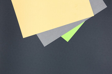 Paper background in pastel shades on a dark background.