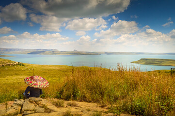 Tourist relaxing in Panoramic Sterkfontein Dam and nature reserve in Drakensberg area