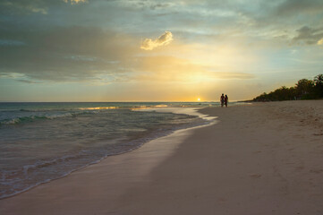 Romantic couple walk with beautiful beach sunset