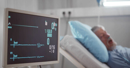 Portrait of senior man in coma dying in hospital bed with heart rate falling on ecg monitor. - obrazy, fototapety, plakaty