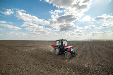Tractor spreading artificial fertilizers