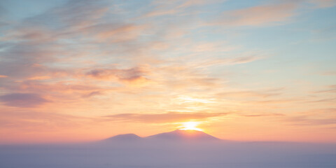 Winter arctic landscape. Sunset over the tundra and snow-capped mountains. Cold winter weather. Frosty fog over the winter tundra. The nature of Chukotka and polar Siberia. Far North of Russia, Arctic