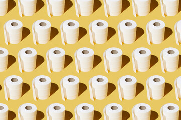 White toilet paper roll on yellow background. - 424163829