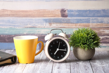  coffee mug, notepad and clock on table close up 