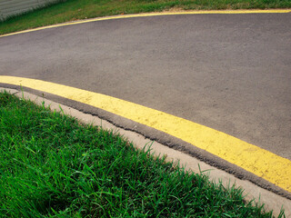 Obraz premium Cycling or jogging track and green grass in the park