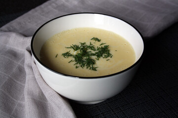Cheese soup in a white bowl.