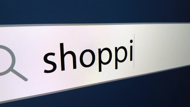 Shopping written in search bar with cursor, computer monitor, close-up with camera zoom effect