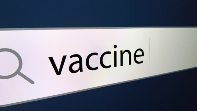 War vaccine at the end of a question mark written in a search bar with a cursor, a computer monitor, close-up with a camera zoom effect