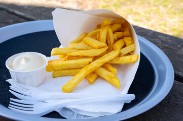 Street or take away food, fresh baked french fried potatoes chips in paper cone