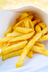 Street or take away food, fresh baked french fried potatoes chips in paper cone