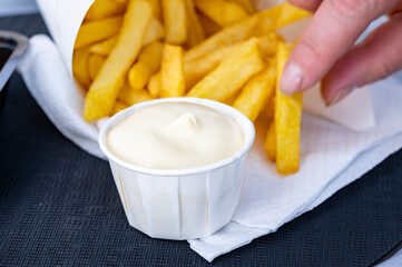 Street or take away food, fresh baked french fried potatoes chips in paper cone