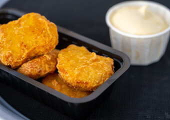 Street or take away fast food, chicken nuggets with mayonnaise sauce