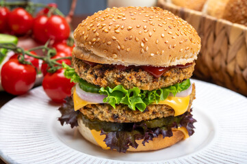 Tasty vegetarian cheeseburgers with round patties or burgers made from grains, vegetables and legumes