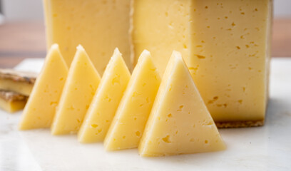 Cheese collection, Tomme de Savoie cheese from Savoy region in French Alps,  mild cow's milk cheese with beige interior and thick brownish-grey rind