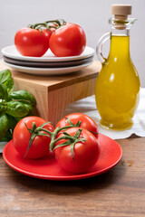 Vegetarian food - ripe red sweet tomatoes, green basil and extre virgin olive oil