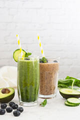 Healthy drinks food. Fresh pink and green smoothie. Spinach smoothie with cucumber and banana smoothie with berries