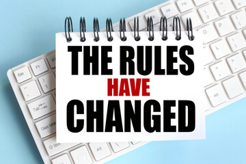 The Rules Have Changed. time to restart. text on white notepad paper on white keyboard
