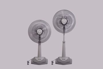 Two Electric slide fans, Adjustable height and low, Isolated on gray background.