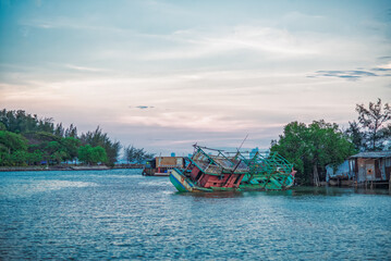 Fototapeta na wymiar Wooden Colourful Fishing boats at rest in port, Eastern of Thailand.