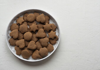 Creamy honey cookies with cocoa in a white dish. Homemade natural pastries for a holiday or every day.