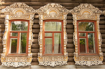 Carved windows on the old wooden house of the city of Tomsk (Russia). Russian style in architecture, summer 2019