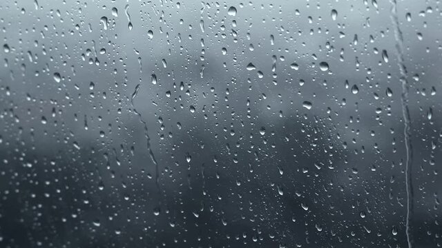 raindrops on window in dark grey background