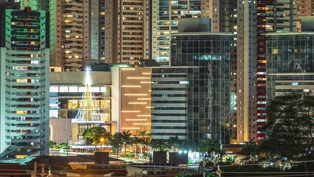 Time lapse of a big city with tall buildings at night, urban night life. Zoom Out camera movement on buildings to a wide view. Cityscape of Londrina city, PR, Brazil at Gleba Palhano neighborhood.