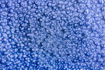 Colorful bubbles of fluid on glass surface