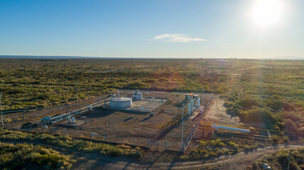 aerial view of oil collection battery at sunset