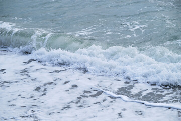 Air is cool and fresh. Minimalistic ocean background. Seascape of gently undulating sea and waves with white foam. Blue and sometimes turquoise cold North Sea.