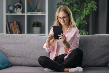 Woman with tablet on couch