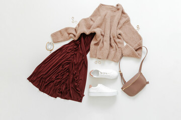 Female spring look autumn outfit burgundy skirt beige sweater white shoes sneakers bag. Folded fly...