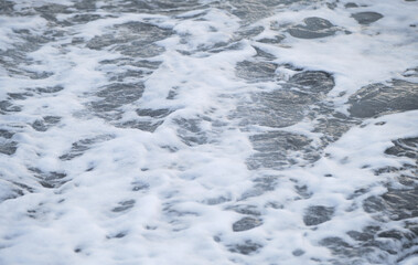 Air is cool and fresh. Minimalistic ocean background. Seascape of gently undulating sea and waves with white foam. Blue and sometimes turquoise cold North Sea.