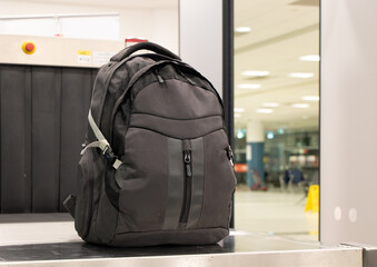 Backpack standing in front of luggage scanner at airport terminal. Baggage at checkpoint at departure gate.