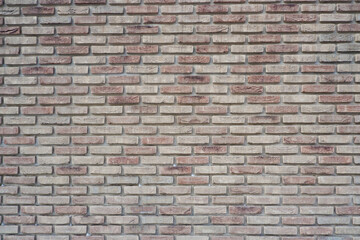 The wall is made of ceramic clinker bricks. Natural urban background. Space for creativity and text. Seamless background- abstract nature pattern.