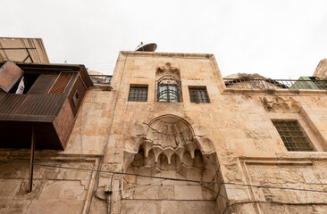 The facade  of a residential building decorated with decorative stucco in the Arabian style, in the old city of Jerusalem, Israel