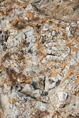 Rock of attractive shade and bulge. Unusual beautiful orange stone texture. Minimalistic geological background for desktop or advertising. Light yellow stone on rock close up.