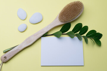 Blank white sheet for your text and natural bristle brush for anti-cellulite lymphatic drainage dry...