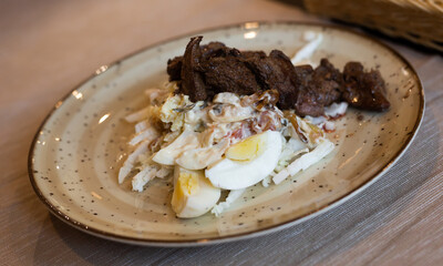 warm salad with chicken liver, cabbage and boiled egg