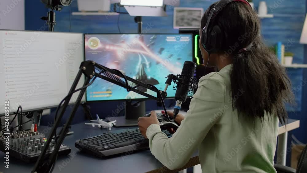 Poster Streamer cyber performing space shooter video game holding controller on RGB powerful computer talking with players on stream chat and microphone during professional competition. Player man streaming