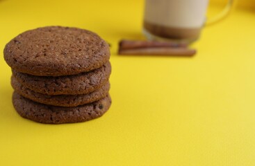 The cookie homemade oatmeal lies a stack of slides on a yellow bright background with room for text and copyspace