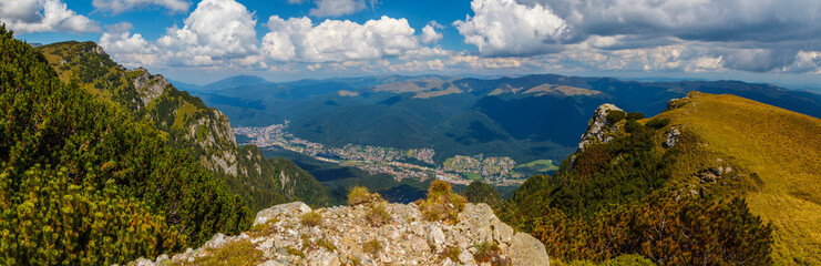 Impressive panorama view on Busteni City from Bucegi mountains, in a summer day, Prahova County, Romania