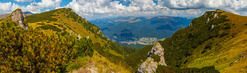 Fototapeta premium Impressive panorama view on Busteni City from Bucegi mountains, in a summer day, Prahova County, Romania