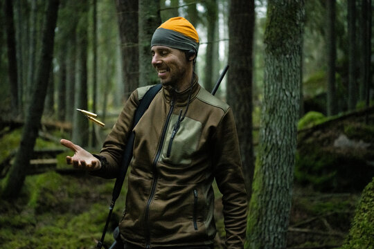Hunter in forest throwing bullets