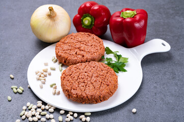 Tasty uncooked burger made with vegetarian plant based imitation minced meat ready for grill