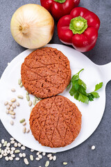 Tasty uncooked burger made with vegetarian plant based imitation minced meat ready for grill