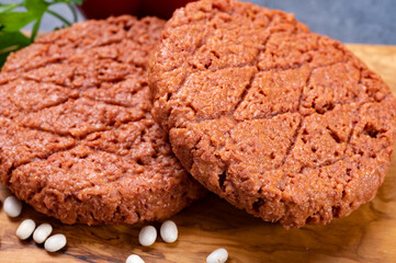 Tasty uncooked burger made with vegetarian plant based imitation minced meat ready for grill