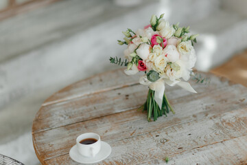 wedding morning.wooden vintage white coffee table and wedding bouquet. . High quality photo